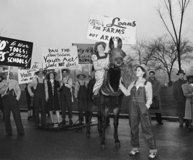 Anti-war protesters against World War II holding signs circa 1940 .