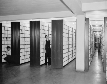 United States Patent office workers looking through collection of over 2,000,000  patents circa 1940 .
