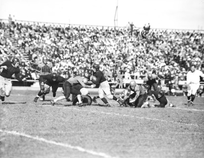 Running back Sneed Schmidt drives through the line in Navy's 18-6 defeat of William Mary to open the 1936 football season.