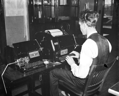 Worker operating a new radio teletypewriter service which allows for instantaneous transmission of written records without the aid of wires, has been perfected by the experts of the Bureau of Air Comm...