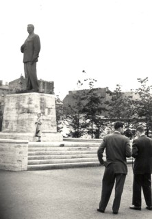 Photograph of two men and a woman in front of the former statue of Joseph Stalin on what is now Karl Marx Allee in Berlin, taken in 1955 (statue removed in 1961?) .