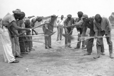 African American convicts working with shovels, possibly the singers of 'Rock Island Line' at Cummins State Farm, Gould, Arkansas, 1934.