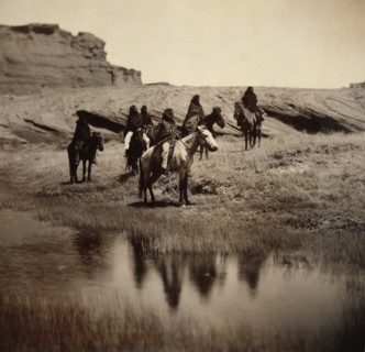 Edward S. Curits Native American Indians - Six Navajo on horseback, water in foreground circa 1904.