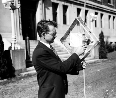 Dr. L.F. Curtiss, of the U.S. Bureau of Standards, is shown here with part of the equipment he uses in experiments using radio to gather meteorological data at great altitudes circa 10/17/1935.