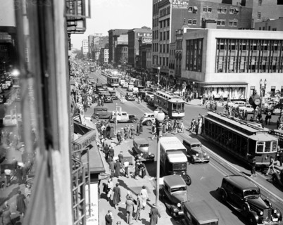 Streetview of Washington D.C. with busy traffic of cars and streetcars circa 1935.