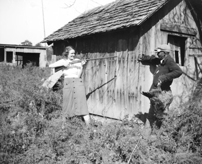 Edna Morris, who lives within a few hundred feet of the government-owned 'Tugwelltown' being constructed near Washington by Rehabilitation Administration, arms herself to protect her property against ...