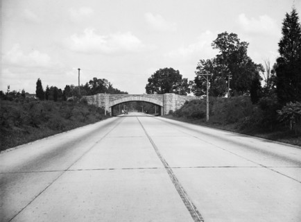 Empty road with bridge in background circa 1934.