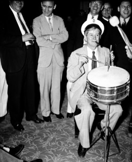 Congressional musicians, gave the House a treat last night, by playing a number of old tunes. Congressman playing drums and smoking cigar 8/27/35.