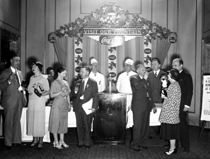 Coca-Cola display and people drinking coca-cola circa 1934.