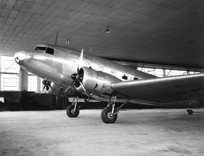 Passenger airplane circa 1936 inside a hangar.