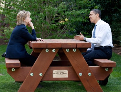 President Barack Obama and Secretary of State Hillary Rodham Clinton speak together sitting at a picnic table April 9, 2009, on the South Lawn of the White House. .