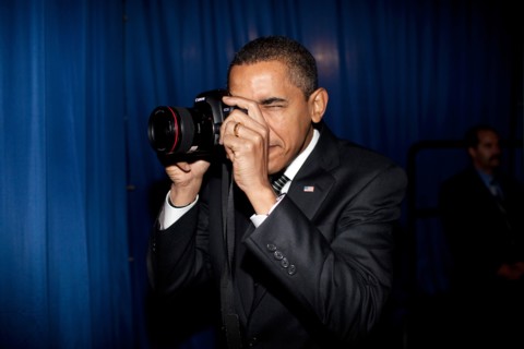 President Barack Obama takes aim with a photographer's camera backstage prior to remarks about providing mortgage payment relief for responsible homeowners. Dobson High School. Mesa, Arizona 2/18/09. ...