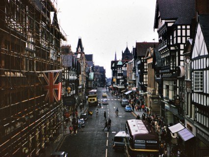 Buses and traffic on a street in Chester England circa July 1973.