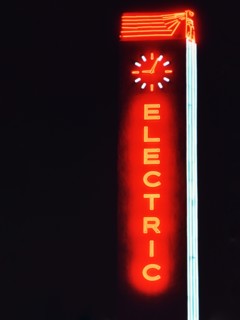 1956 Dallas - Neon sign featuring the word 'Electric' with a clock on top .
