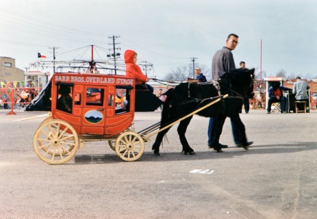 1960 Ft. Worth Stock Show - Little boy riding on a miniature stage coach at the stock show .