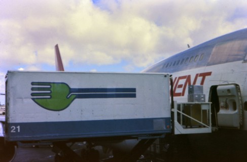 Skychef crew loading a Northwest Orient Airlines plane circa 1976.