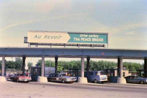 (R) New York 1975 - U.S. Canada border crossing - cars leaving the country circa 1975.