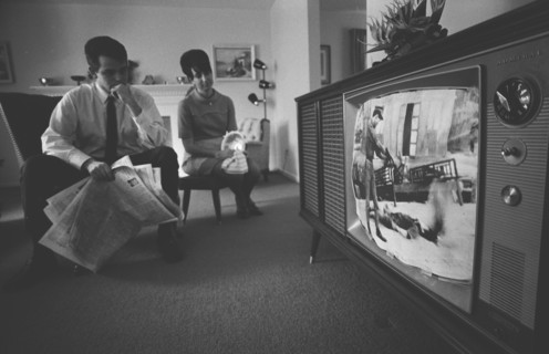 Man and Woman watching Vietnam War TV