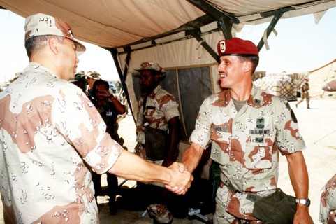 DESERT SHIELD - Colin Powell in fatigues in Saudi Arabia greets Major Fox.