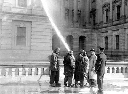 Men cleaning the exterior of the U.S. Capitol
