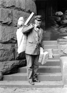 Mailman delivering parcel post packages