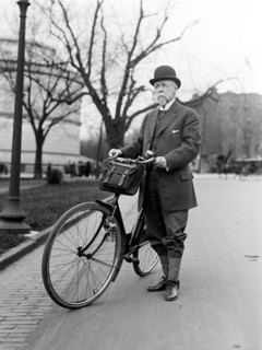 Old man standing next to his bicycle