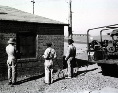 A malaria control detachment sprays billets at Amirabad Post