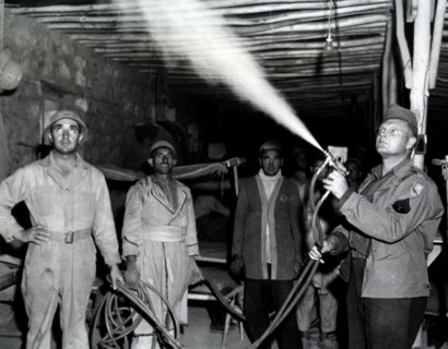 Spraying enlisted men's barracks with DDT at 3rd Platoon