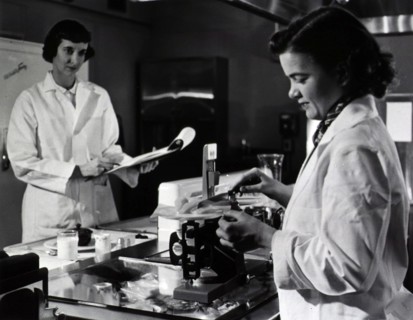 Two female dietitians weigh and measure foods before they are served to patients of restrictive diets.