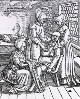 Three midwives attending to a pregnant woman