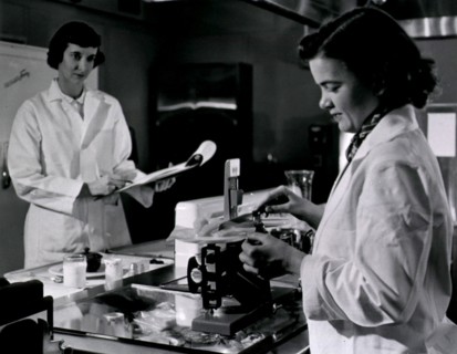 Two female dietitians weigh and measure foods