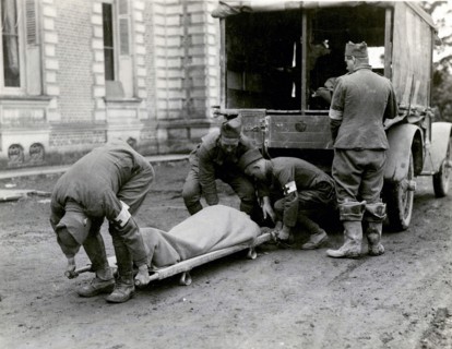 Moving a wounded man from an ambulance