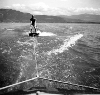 Man skiing behind boat on a board
