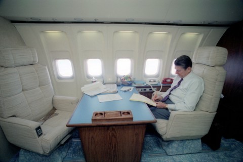 President Reagan working in his Air Force One state room.