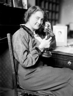 Early 1900s woman sitting and talking on the telephone ca. 1913