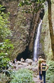 Tourists on a hiking trail visiting Sacred Falls in Oahu Hawaii