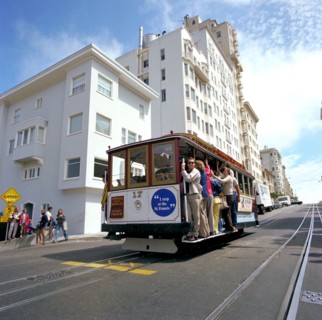 Tourists riding the famous San Francisco cable car