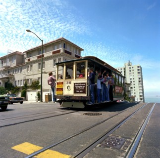 Tourists riding the famous San Francisco cable car