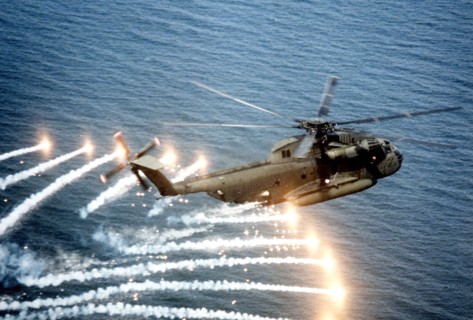 An air-to-air right side view of a CH-53D Sea Stallion helicopter