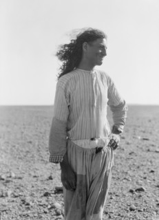 Bedouin life in Trans-Jordan, a bedouin road bulder with long hair in Trans-Jordan ca. 1920