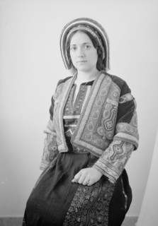 Woman in finely embroidered Ramallah costume, seated, ca. unknown date