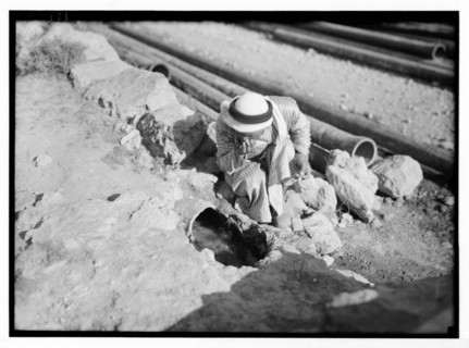 Man looking at ancient aqueducts, the section of Ain Attah aqueduct. Embedded pottery tubes along the Artas road. ca. between 1934 and 1939