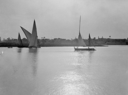 Scene along the Cairo banks of the Nile River, many sailboats on the river  ca. between 1934 and 1939