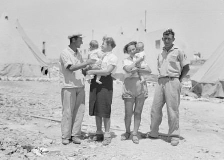 Maalek Hachamisha (Ma'ale HaHamisha) Kibbutz. Group of colonials, immigrants, holding babies ca. 1939