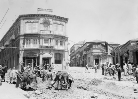 Workers clearing around city wall and digging sewage canals on Jaffa Road, Hotel Fast in the background ca. 1936