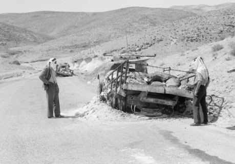 Men observing damage to Palestine Potash lorries burned down on the Jericho road ca. between 1934 and 1939