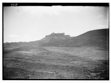 A distant view from the northeast of Krak des Chevaliers and the St. George Monastery ca. 1936