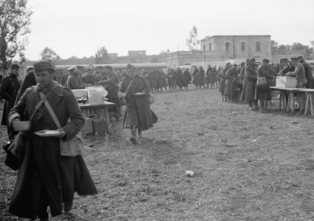 Italian prisoners eating food after detraining at Wady Sarar near the town of Qazaza in Palestine, Dec. 21st, 1940