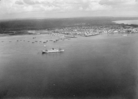 Aerial view of Zanzibar with the H.M.S. Pegasus seen in the port ca. 1936