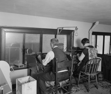 Man and woman cigar rolling ca.  between 1910 and 1926
